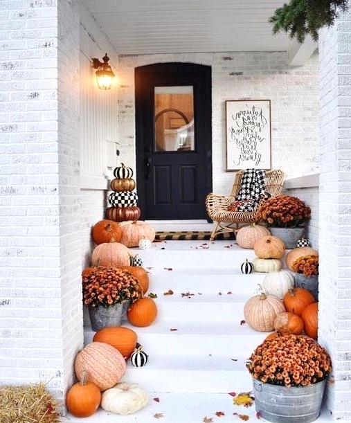 varying shades of orange pumpkins are ideal when creating a classic fall front porch design. 