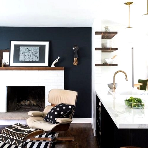 Black living room accent wall with a white brick fireplace