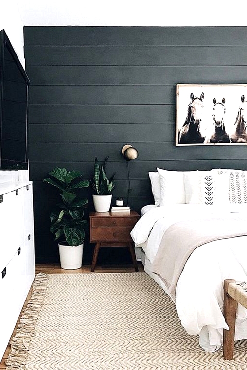 Black shiplap accent wall in a neutral bedroom