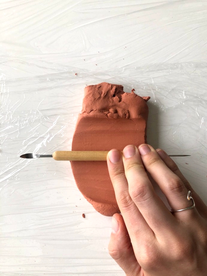 DIY clay pot in a boho style. Rooling out the air dry clay.