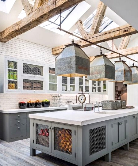 Farmhouse kitchen with galvanized metal lighting and chicken wire cabinet doors 
