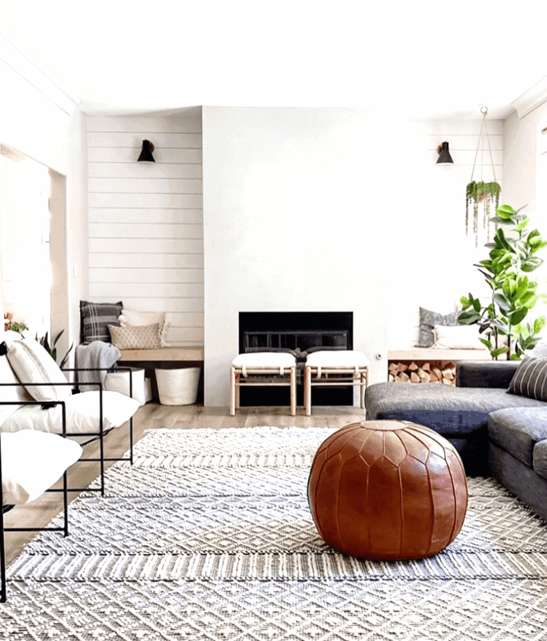 Beautiful modern concrete fireplace paired with shiplap accents walls in this farmhouse inspired living room. Check out this post for more living room inspirations. 