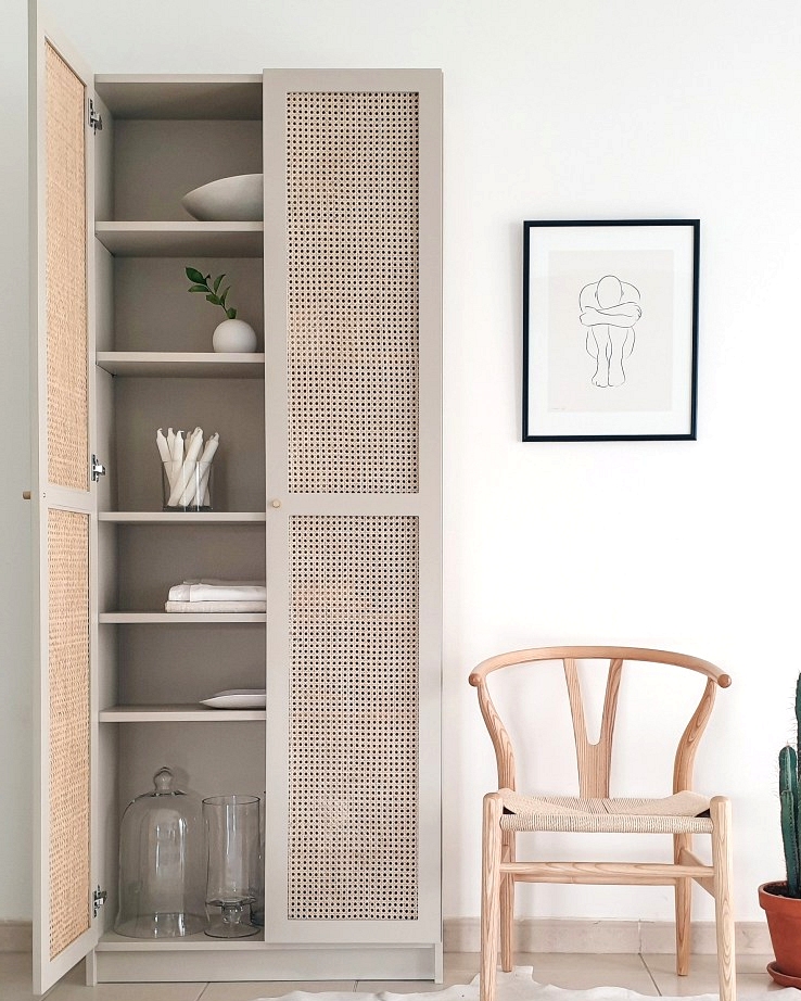 Subtle boho vibes and custom rattan door fronts make this IKEA Billy bookcase makeover beautiful.