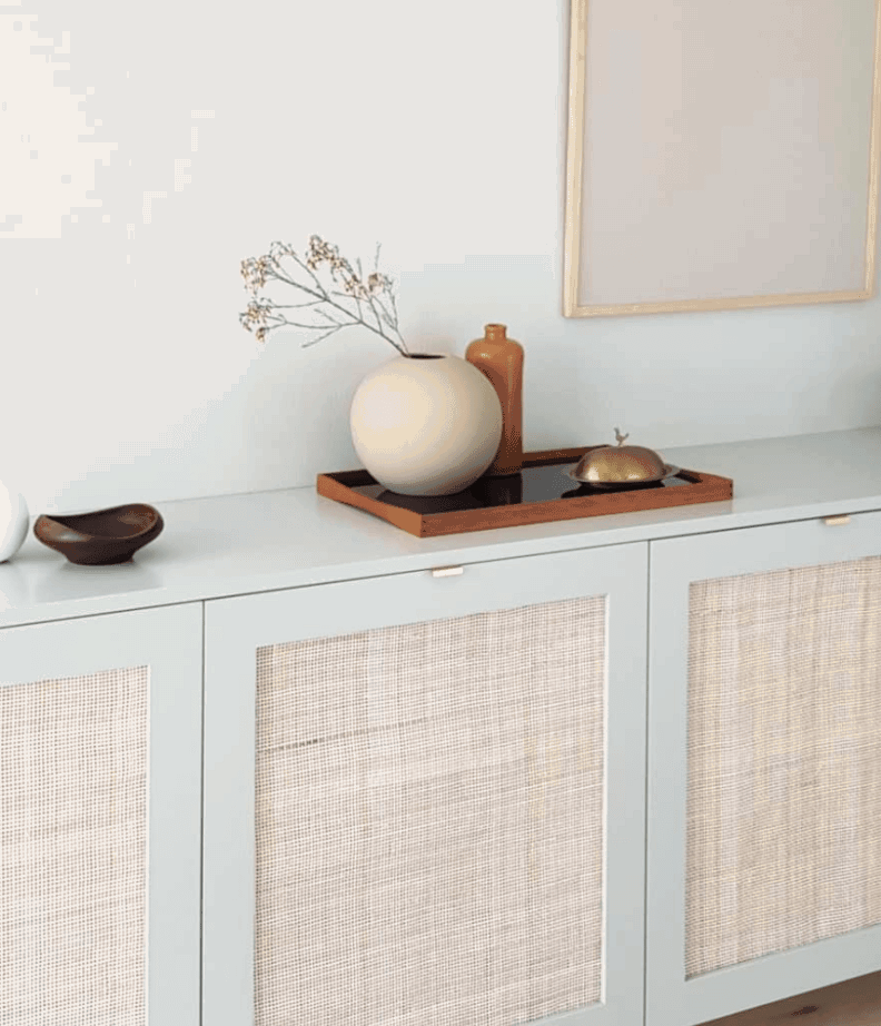 Sophisticated boho chic IKEA cabinet with custom cane door fronts.
