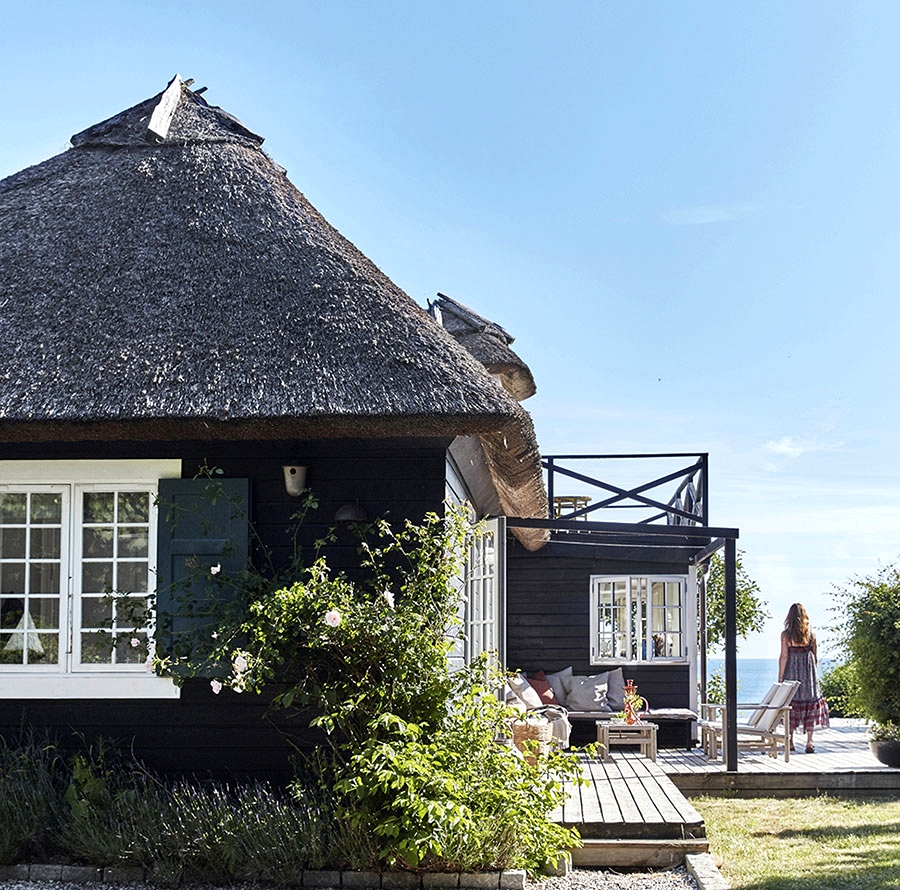 Conventional Danish thatched home proper by the ocean