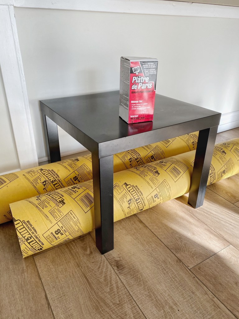 Transform an IKEA LACK side table into a sculptural side table using plaster and concrete tubing. 