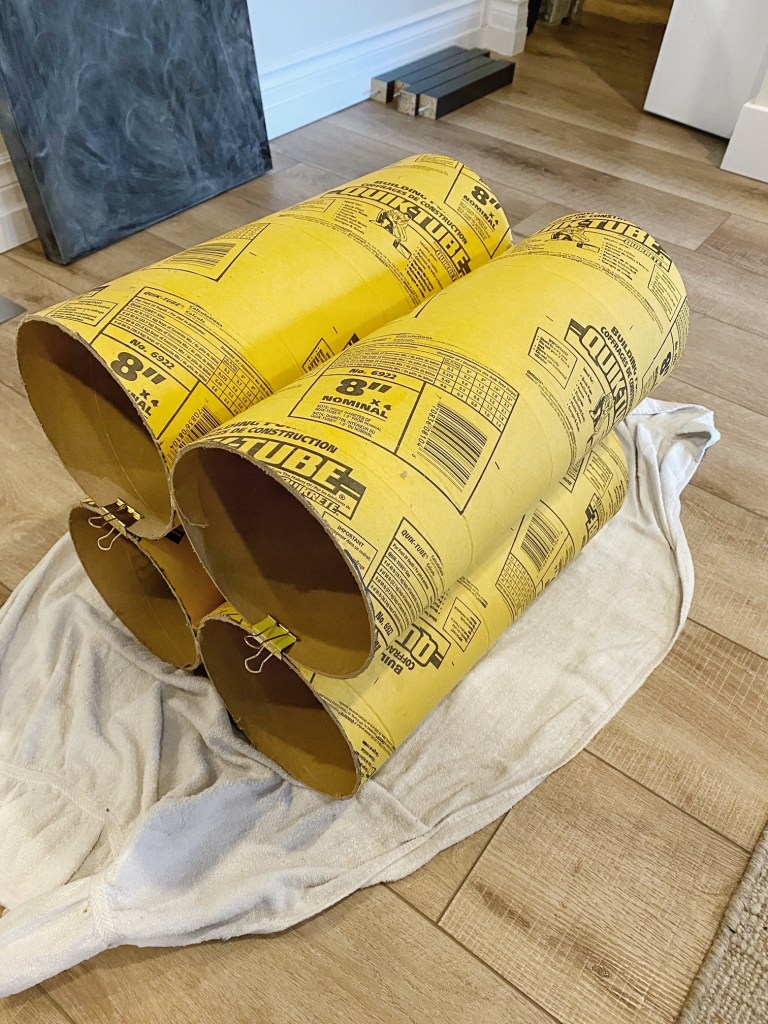 Secure the cardboard tubes of the accent table together until they are dry. 