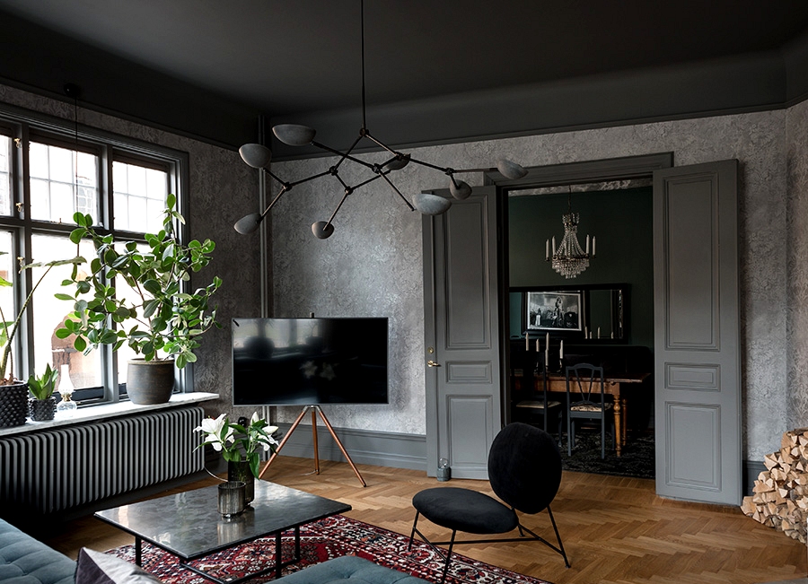 Dramatic dark interiors of magnificent Scandinavian apartment