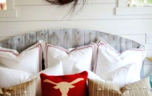 a bed with a whitewashed headboard that feels shabby chic like and adds vintage charm to the room