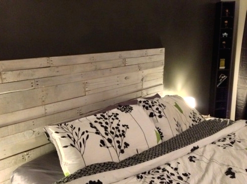 if there's no headboard, you can make one and attach it to the wall, use whitewashed wood to create such a headboard