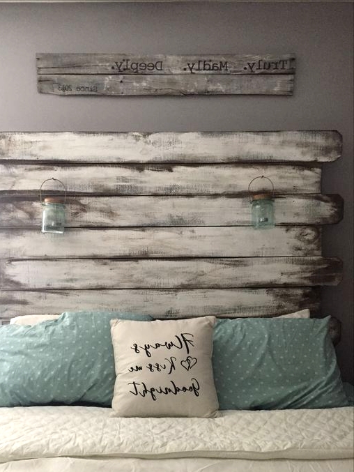 a bedroom with grey walls, a bed with a whitewashed headboard, white and aqua bedding, a sign is a lovely idea for shabby chic lovers