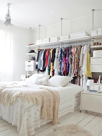 a large makeshift closet with open shelves, drawers, dressers is a huge storage unit that doesn't look bulky and feels very airy