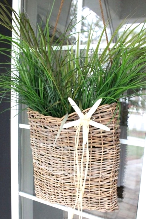 a wicker basket with greenery and a starfish is a lovely decoration for a beach or coastal space, use it instead of a usual wreath on your door