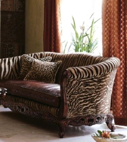 a vintage-inspired brown sofa with zebra print upholstery and a leather seat is a stylish idea for a refined vintage living room