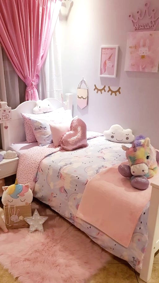 a small and lovely girl's bedroom with white vintage furniture, a pink curtain and bedding, a pink rug and lots of colorful toys