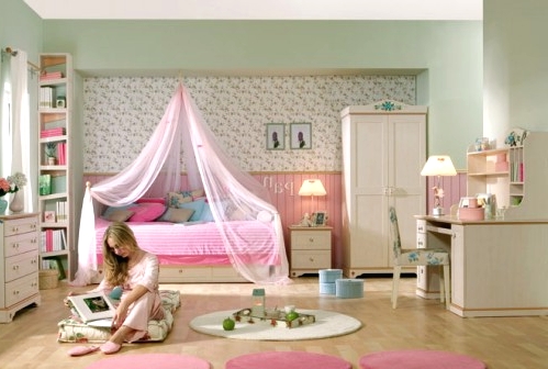 a hot pink and neutral kid's room with pink paneling, pink rugs and cool white furniture, floral wallpaper and a gallery wall
