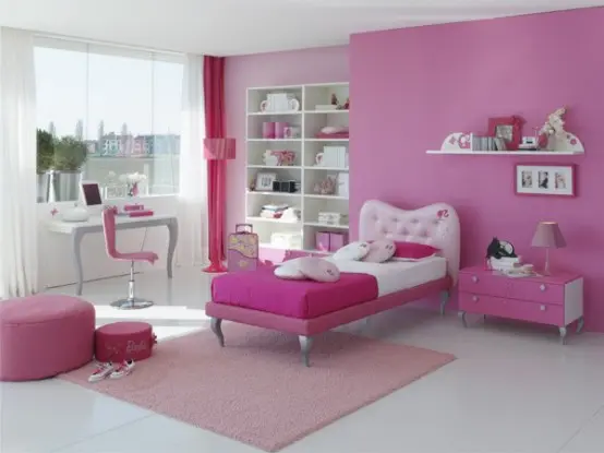 a hot pink and white girl's bedroom with an accent wall, a light pink and hot pink bedding, pink poufs and pink curtains and a chair