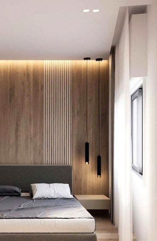 a chic minimalist bedroom with a light-stained accent wall, a grey bed, floating nightstands, black pendant lamps and built-in lights