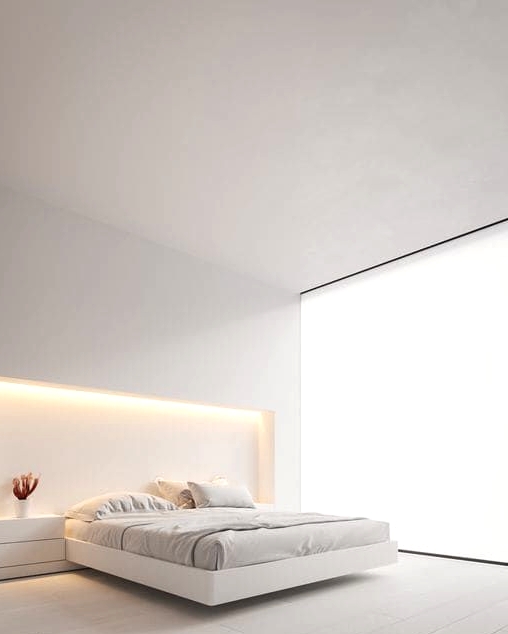 a minimalist white bedroom with a glazed wall covered with a blind, a built-in bed with lights over it, built-in nightstands