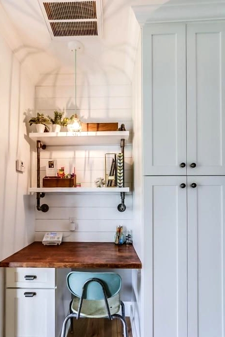 a farmhouse awkward nook done with white shiplap, a built-in desk, built-in shelves, a pendant lamp and potted greenery for working