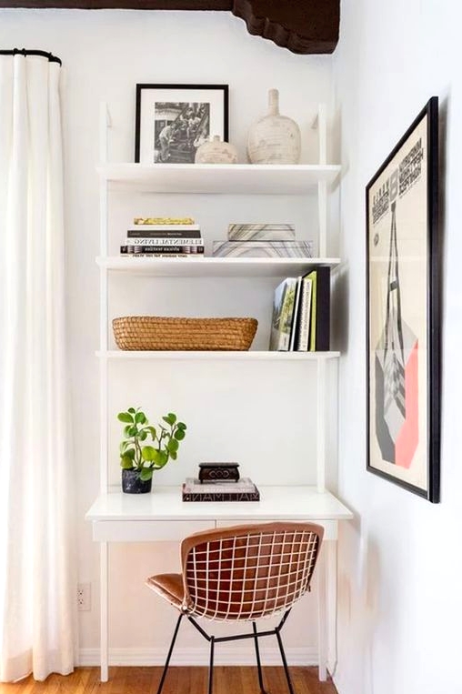 a small nook by the window, with a white shelving unit and desk, a leather chair, potted greenery, books and vases is a very functional idea