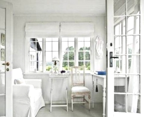 a vintage white Scandinavian home office with shabby chic furniture, lamps is a small yet very chic space