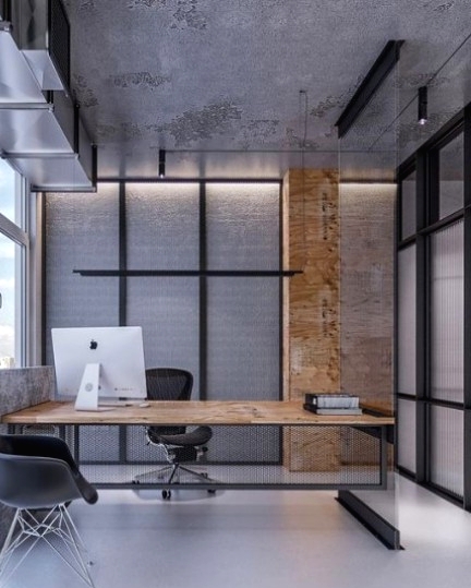 a minimalist meets industrial home office with much concrete and metal in decor, a catchy desk and a glazed wall