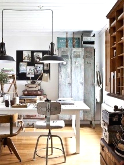 an industrial shabby chic home office with an aged metal cabinet, a simple desk and stools, a large shelving unit of wood