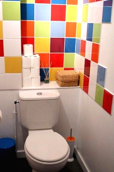 a small and bright powder room refreshed with bright multi-color tiles, with white appliances is a super cool and fresh idea to rock