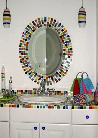 a white bathroom accented with super bright and colorful tiles on the vanity and mirror frame is a great idea for a kid's bathroom