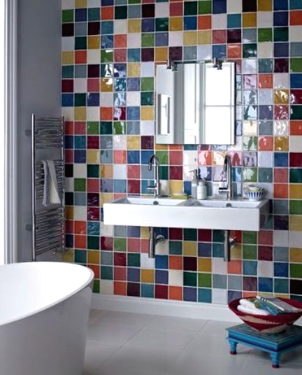a modern white bathroom with an accent wall clad with super bright and bold tiles and with all white everything looks cool and cheerful