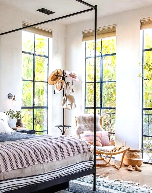 floor to ceiling windows create a light feeling in the bedroom and fill it with natural light
