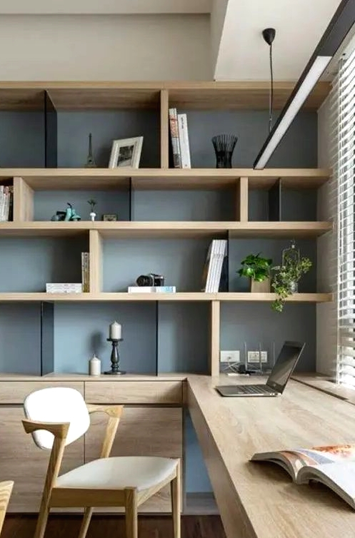 a chic contemporary home office with a storage unit that takes a whole wall, with open and closed storage compartments, a built-in desk and chic modern chairs