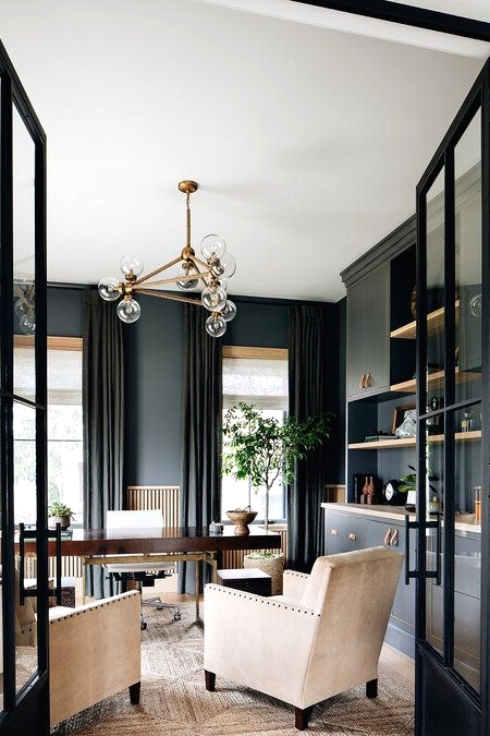 a sophisticated graphite grey home office with matching cabinets for storage an elegant stained desk and creamy chairs