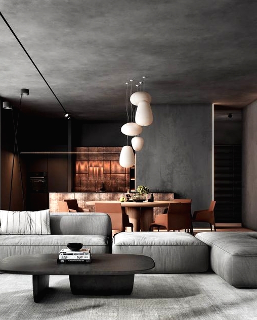 a contemporary space with a concrete ceiling and walls, an amber dining zone, a grey sofa and a low coffee table