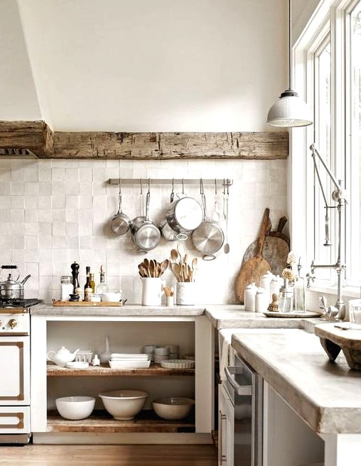 a wabi-wabi kitchen with open cabinetry, a reclaimed wooden beam covering the hood, concrete countertops and a neutral zellige tile backsplash