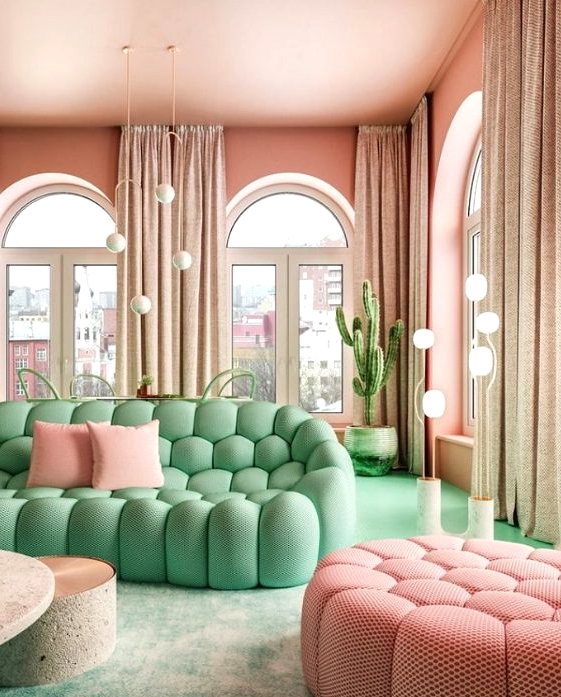 a whimsical living room with pink walls and a ceiling, neutral curtains, a pastel green sofa and a pastel pink ottoman, a green floor and planters