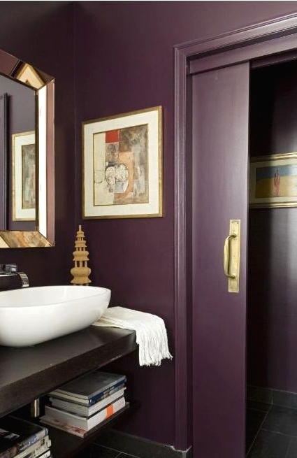 a chic aubergine bathroom, a floating vanity, metallic touches, a vessel sink and sliding doors