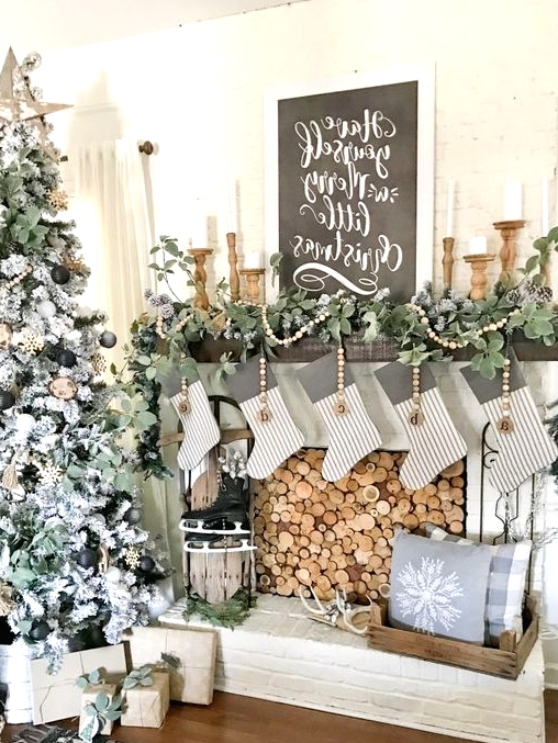 beautiful and cozy neutral rustic Christmas decor with wooden beads, greenery garlands, wooden candleholders, skates and striped stockings