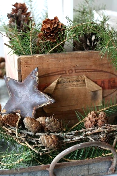 a crate and a tray with evergreens, pinecones, a metal star are all you need for a lovely relaxed rustic look