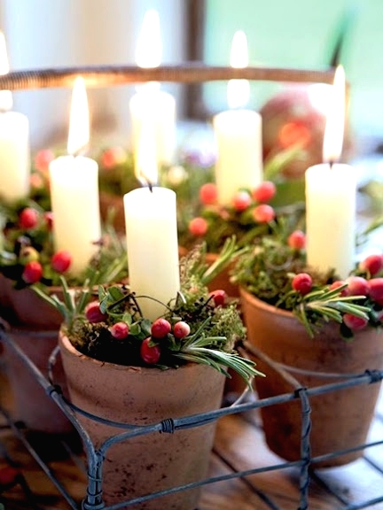 a wire tray with small planters with evergreens, red berries and candles is a lovely realxed rustic Christmas decoration
