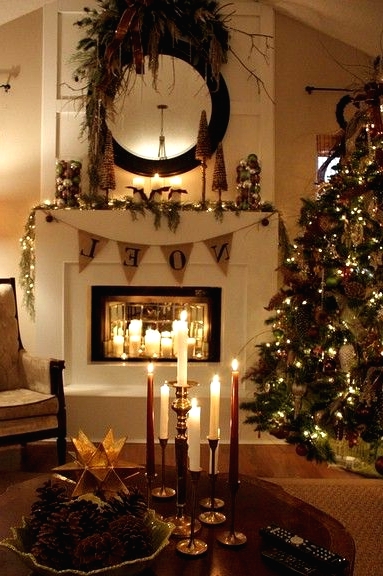 a rustic Christmas mantel with a burlap garland, Christmas ornaments, pinecones, greenery, a large bow and a bowl with pinecones on the table