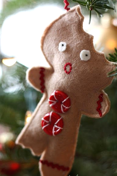 a half eaten felt Christmas ornament with red buttons and embroidery is a pretty and fun decoration for the holidays