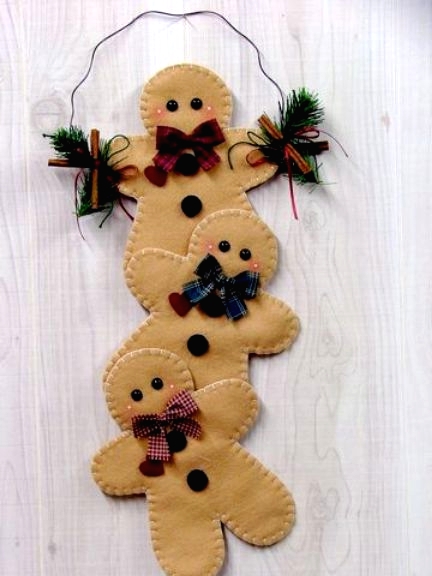a decoration composed of felt gingerbread men and evergreens is a lovely idea for Christmas decor, it will bring a soft and cozy feel to the space
