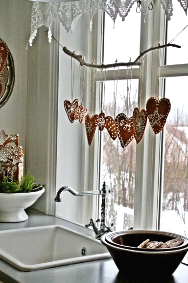 beautiful glazed gingerbread hearts as a garland on the window is a cute idea for a Scandi-inspired Christmas space
