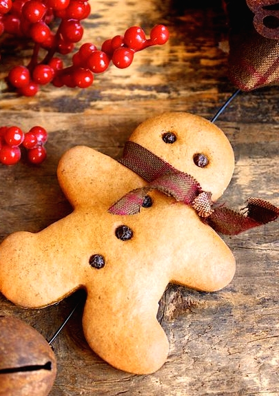 a real gingerbread man with a burlap bow is a tasty cookie and a lovely Christmas decoration