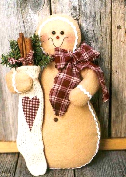 a real oversized Christmas gingerbread cookies with a scarf, a stocking with evergreens and cinnmon sticks is a lovely decoration