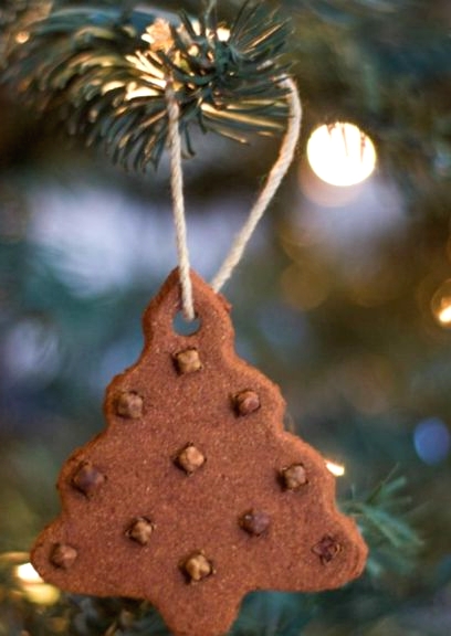 a gingerbread Christmas tree cookie with nuts is a lovely and tasty ornament to make yourself