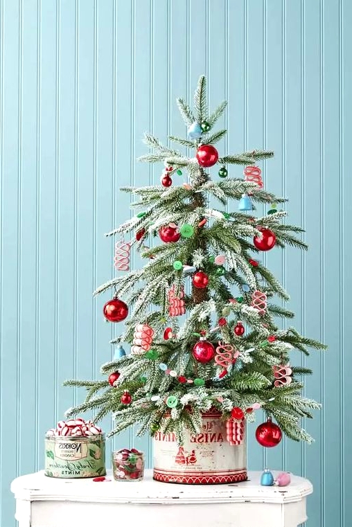a retro-inspired tabletop Christmas tree with blue bells, red and green ornaments, buttons is a lovely idea for your space