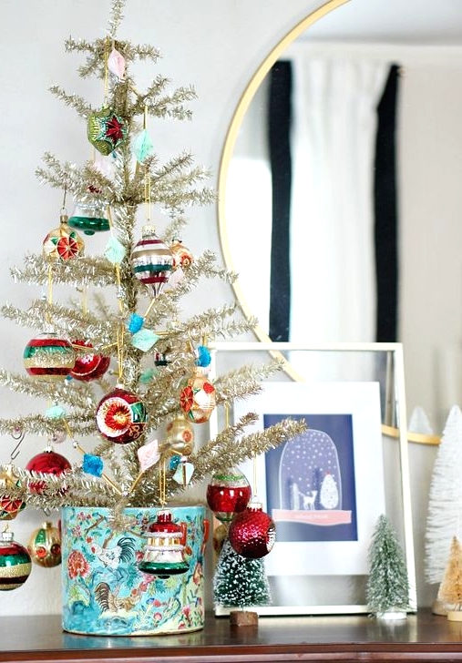 a gold vintage Christmas tree decorated with colorful vintage ornaments is a pretty idea to go for